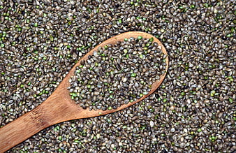 Wooden Spoon Filled With Raw Unshelled Hemp Seeds On Textured Background