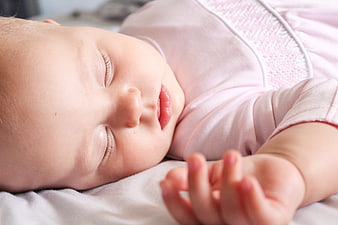 Peaceful sleeping newborn baby girl close-up portrait