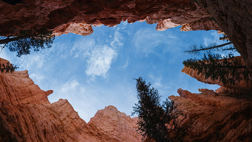 Low angle view of red rock hoodoos and blue sky