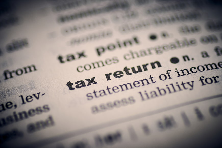 Close-up of tax return definition in dictionary