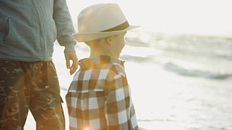 Father and Son Walking on Beach at Sunset