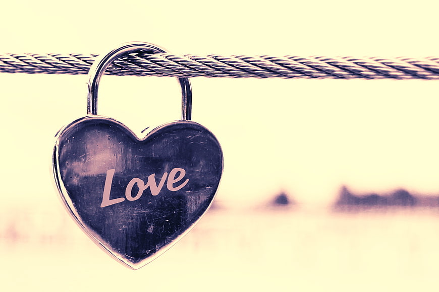 Heart-shaped padlock with love inscription on cable
