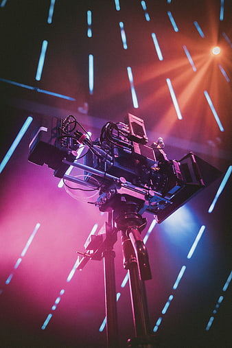 Professional Cinema Camera on Tripod with Neon Lights