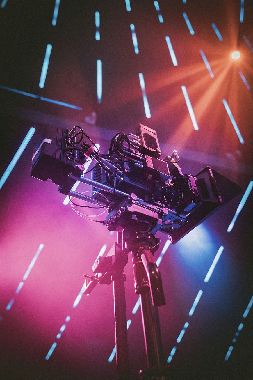 Professional Cinema Camera on Tripod with Neon Lights
