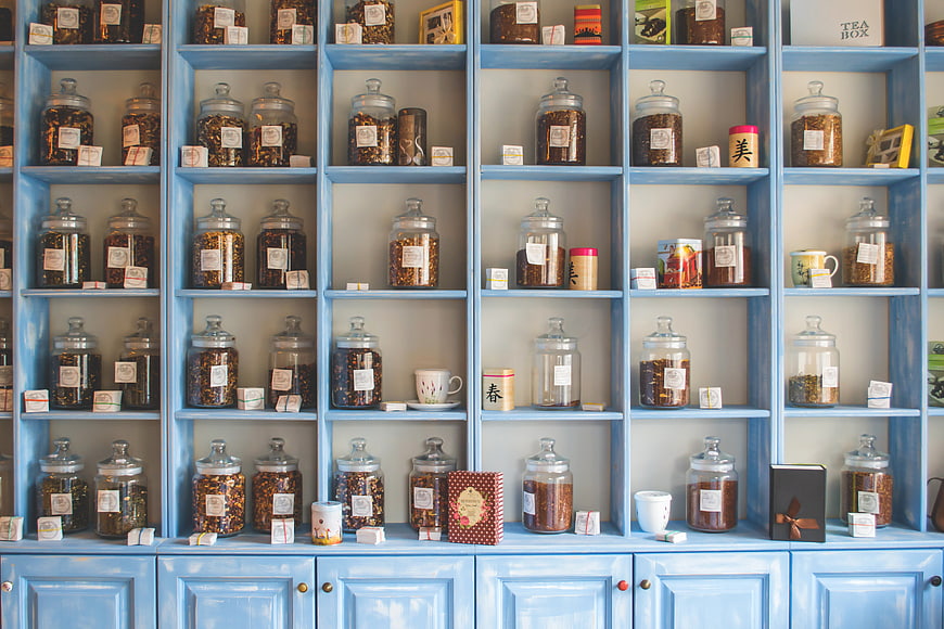 Blue Shelves Filled with Glass Tea Jars and Loose Leaf Tea