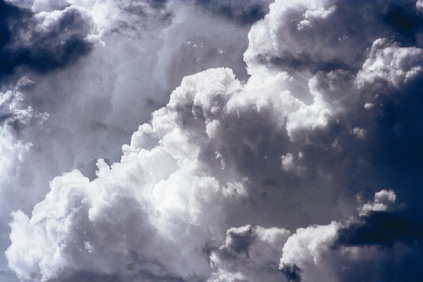 Dramatic Cumulus Clouds Against Deep Blue Sky
