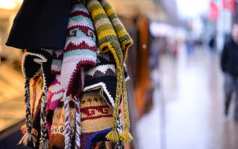 Colorful Knitted Winter Hats Hanging in a Market Stall