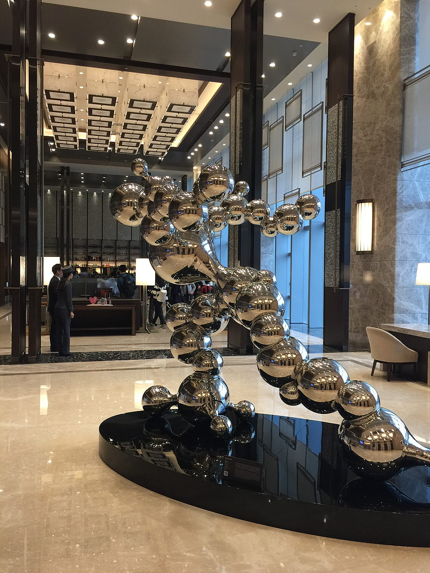 Modern chrome balloon sculpture in luxury hotel lobby