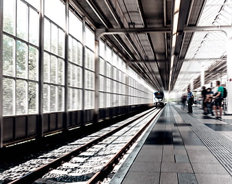 Motion blur train arriving at modern station platform