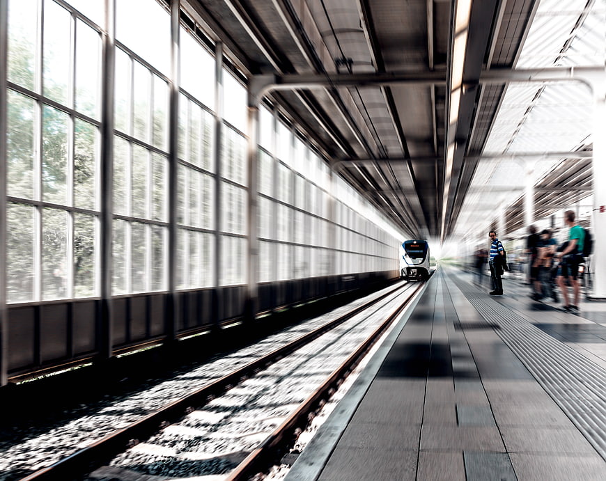 Motion blur train arriving at modern station platform