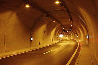 Empty Curved Highway Tunnel With Warm Yellow Lighting And Perspective