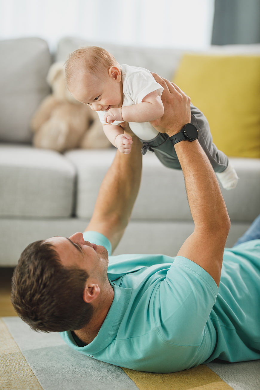 Father Playing with Baby on Living Room Floor