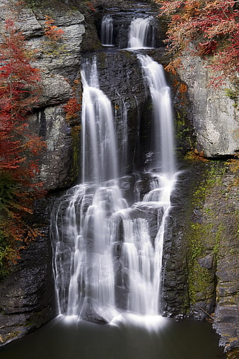 Majestic Autumn Waterfall Cascading Over Rocks