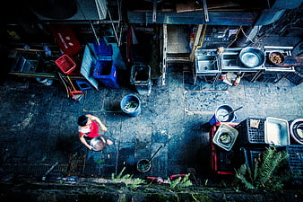 High angle view of woman washing dishes in outdoor kitchen