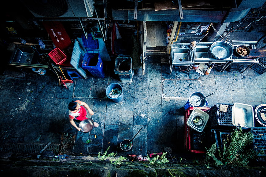 High angle view of woman washing dishes in outdoor kitchen