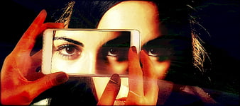 Woman holding smartphone with double exposure artistic effect