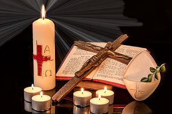 Easter Candle, Cross, Bible, and Palm Branch on Black Background