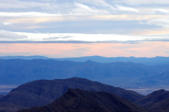 Layered Mountain Ranges at Sunset with Pink Sky