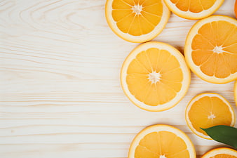Fresh Sliced Oranges Flat Lay on Light Wooden Background