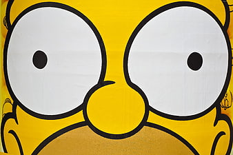 Close-up of yellow cartoon character face with large white eyes