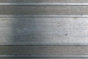 Textured brushed metal surface with industrial grooves and scratches