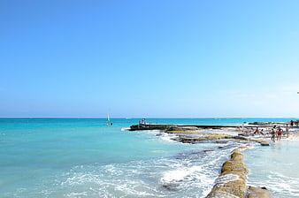 Tropical Beach Scene With Turquoise Water And Rocky Shoreline