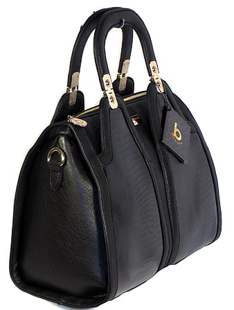 Black textured leather handbag with gold hardware and retail tag on white background