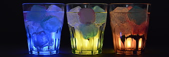 Three Colorful Glowing Drinks with Ice Cubes