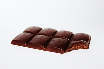 Broken Milk Chocolate Bar with Orange Filling on White Background