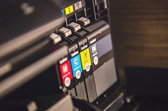 Close-up of Brother printer ink cartridges in CMYK colors