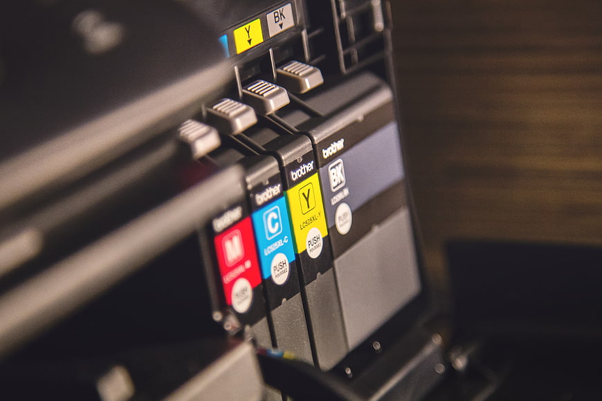 Close-up of Brother printer ink cartridges in CMYK colors