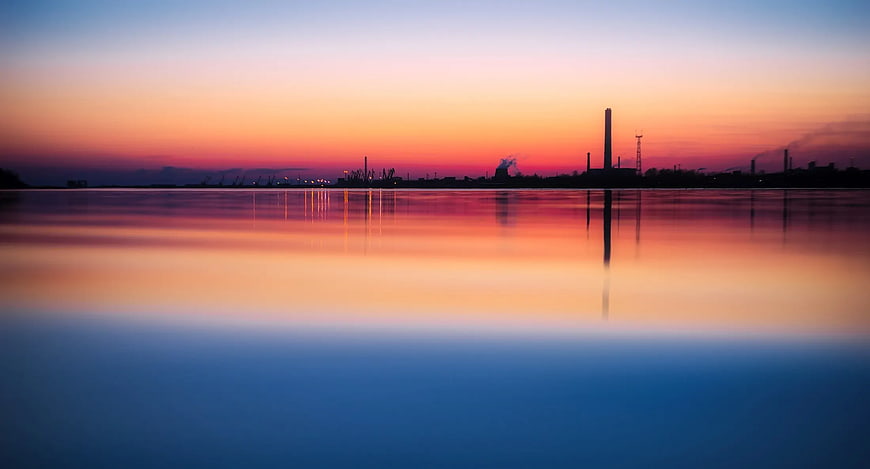 Serene Sunset Reflection Over Industrial Harbor Silhouette