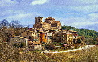 Historic stone village with church on a hillside