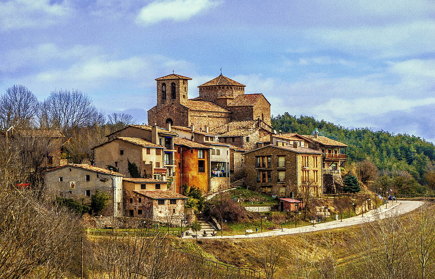 Historic stone village with church on a hillside