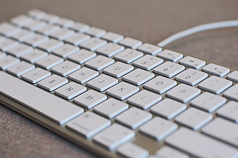 Close-up of White Computer Keyboard on Desk