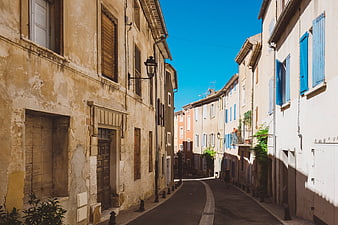 Narrow European Street with Colorful Shutters and Blue Sky