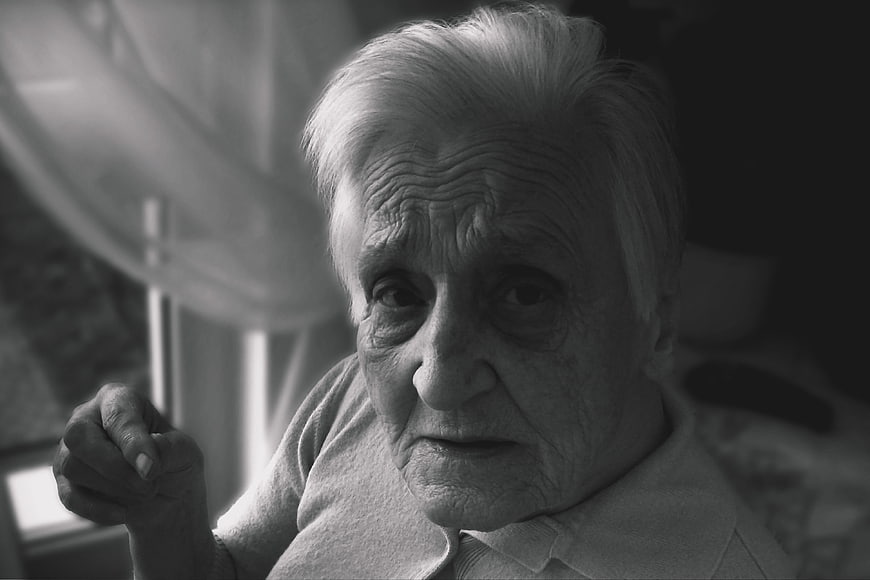 Black and white portrait of elderly woman with dementia