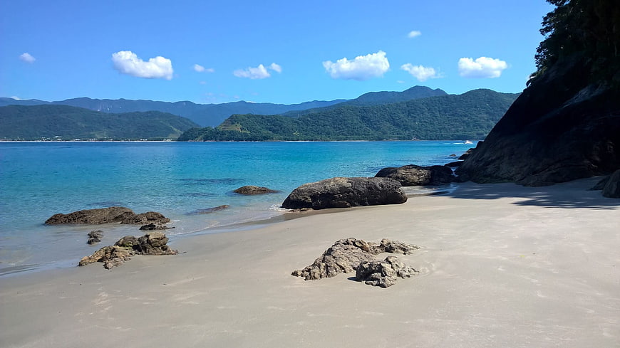 Serene tropical beach with turquoise water and rocky shoreline