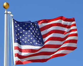 American Flag Waving Against Clear Blue Sky