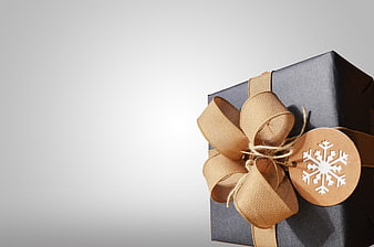 Elegant Black Gift Box with Gold Ribbon and Snowflake Tag