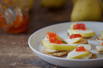 Gourmet pear and cheese appetizers with red jam on crackers