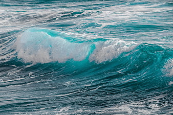Turquoise Ocean Wave Breaking With White Sea Foam