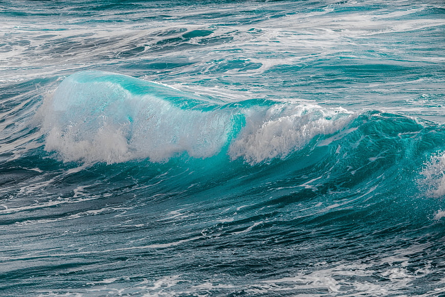 Turquoise Ocean Wave Breaking With White Sea Foam