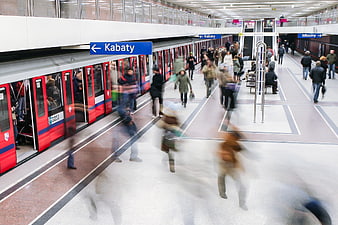 Motion blur of commuters on a Warsaw metro platform