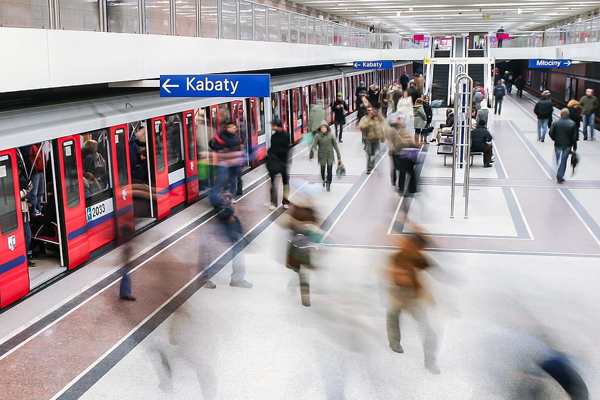 Motion blur of commuters on a Warsaw metro platform