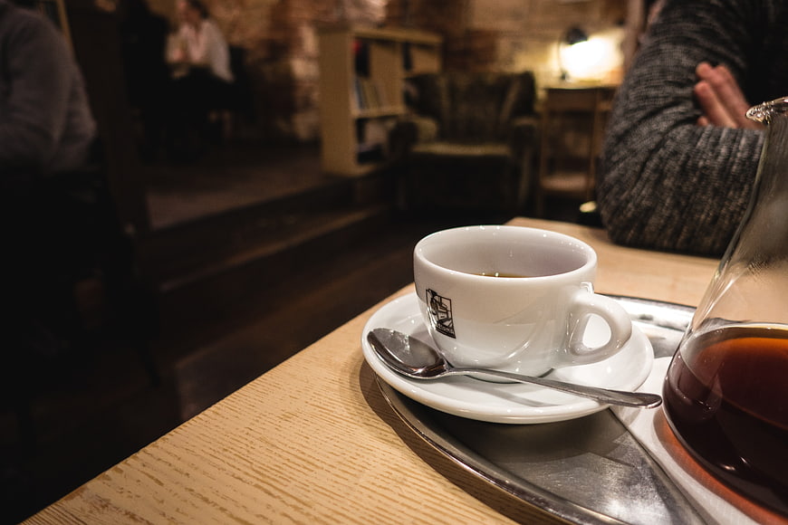 Filtered coffee cup on wooden table in cozy cafe