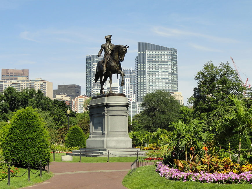 Paul Revere statue in Boston Common park with city skyline