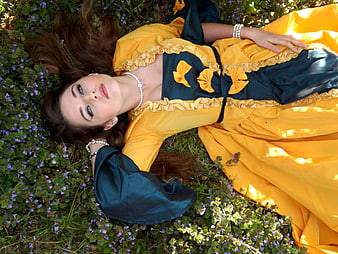Woman in Yellow and Blue Dress Lying in Flowers