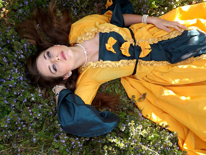 Woman in Yellow and Blue Dress Lying in Flowers