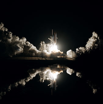 Space Shuttle Night Launch with Water Reflection